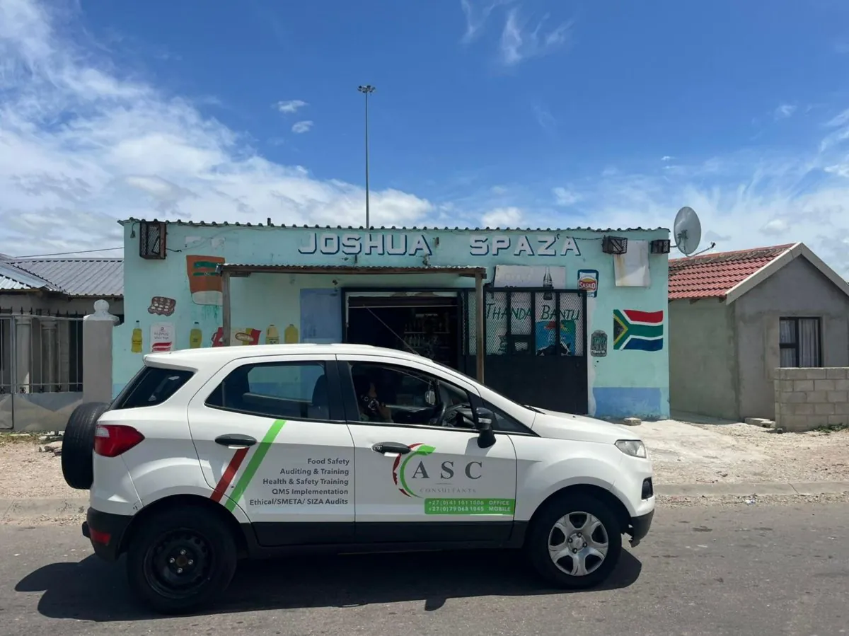A branded ASC Pest Control vehicle on site at a township spaza shop